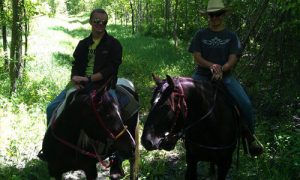 two people riding horses